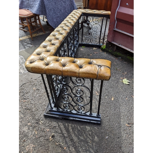 530 - A mid 20th century black painted wrought iron club fender with a button leather upholstered top
Loca... 