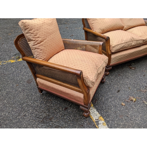 532 - A 1920's walnut framed bergère three piece suite with shot silk style fabric on ball and claw feet
L... 