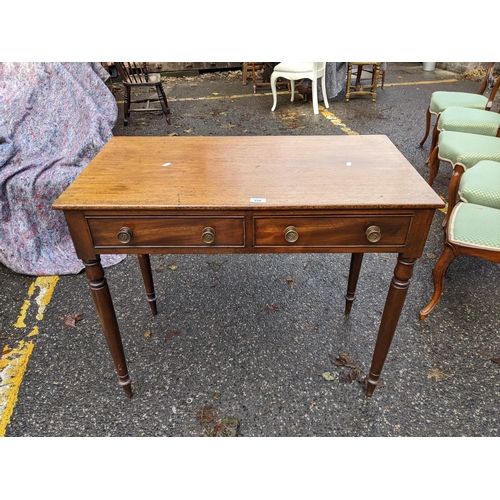 534 - An early 19th century mahogany side table with two drawers, on turned legs, 75cm h x 92cm w
Location... 