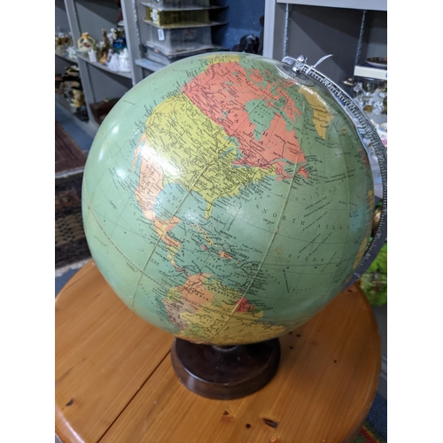 570 - A mid 20th century Philips Challenge Globe, on a wooden stand, 46cm h
Location: ROS
If there is no c... 