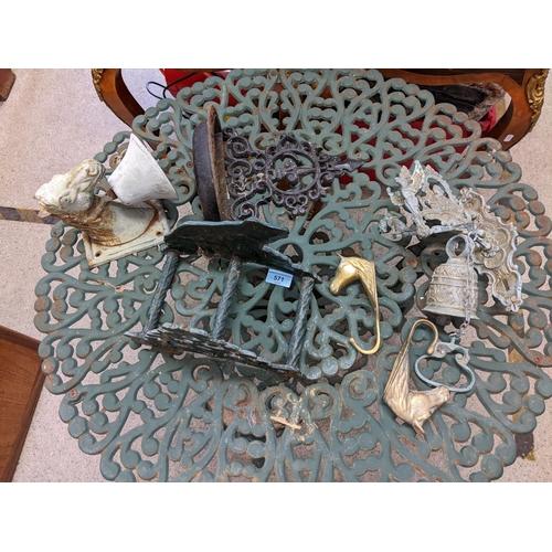 571 - A green painted metal garden table a shoe scraper, a bell in the form of a horse head and another
Lo... 