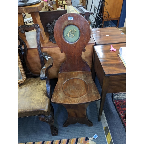 575 - A Regency mahogany hall chair with an initialled back, a solid seat and panelled legs
Location: RAM
... 