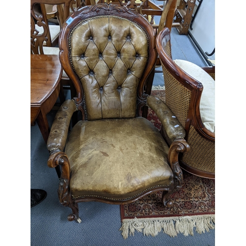 582 - A Victorian carved walnut framed spoon back armchair upholstered in green/brown leather
Location: A1... 