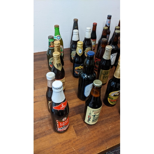 409 - A collection of 61 unopened beer bottles from breweries in the UK and from around the world to inclu... 