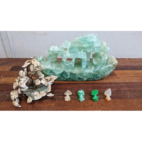 493 - A jade coloured carved stone junk, a mother of pearl and stone model plant and model fish Location: ... 