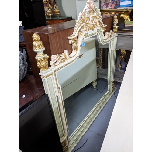 555 - A matching cream painted overmantel style wall mirror, moulded floral decoration with green highligh... 