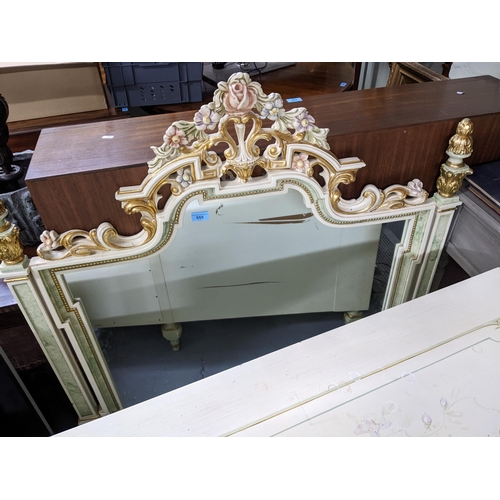 555 - A matching cream painted overmantel style wall mirror, moulded floral decoration with green highligh... 