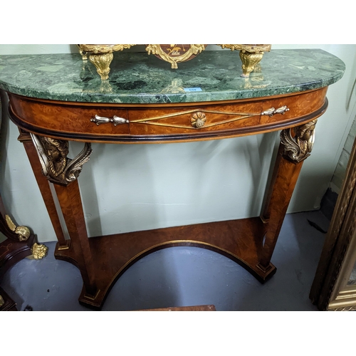 559 - An Italian demi lune walnut console table with ebonized and gilt highlights, green variegated marble... 