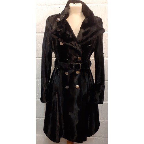 10 - Karen Millen- A black fitted coat having a pony skin effect with matching belt and branded silver to... 