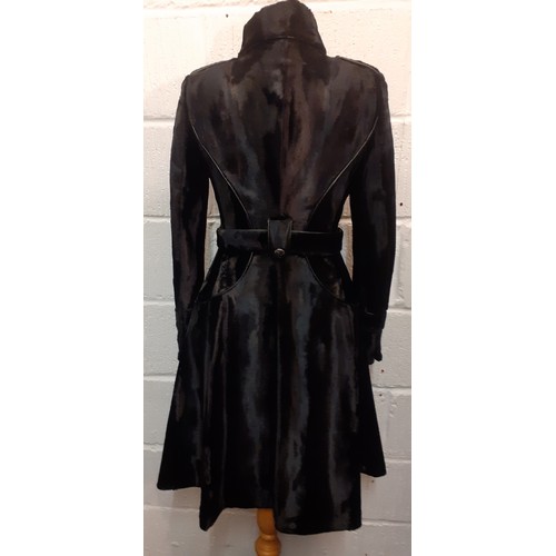 10 - Karen Millen- A black fitted coat having a pony skin effect with matching belt and branded silver to... 