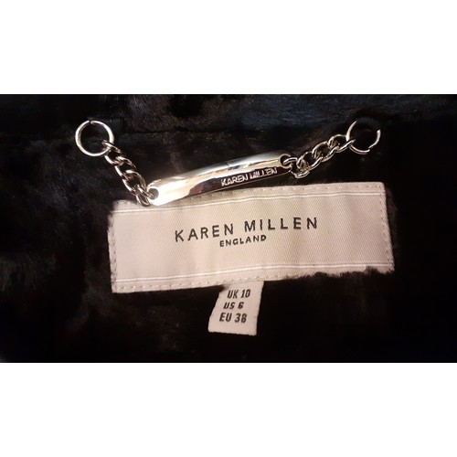 10 - Karen Millen- A black fitted coat having a pony skin effect with matching belt and branded silver to... 