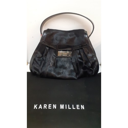 12 - Karen Millen-A black pony skin effect and patent handbag with silver tone hardware, an interior zipp... 