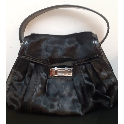 12 - Karen Millen-A black pony skin effect and patent handbag with silver tone hardware, an interior zipp... 