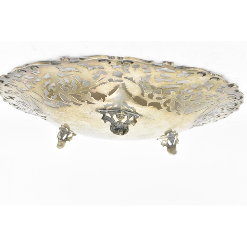 163 - A Continental white metal pierced fruit bowl, circa 1900s, the pierced border with scrolled foliage,... 