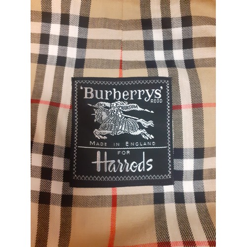 14 - Burberrys for Harrods- A beige raincoat with iconic tartan lining having 2 internal pockets, hardly ... 