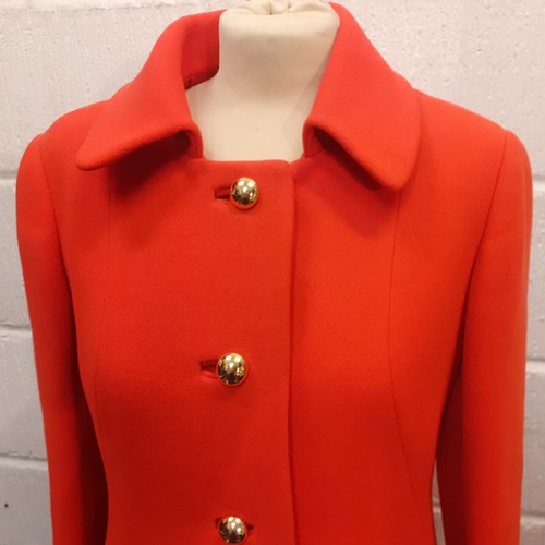 15 - Aquascutum for Harrods- A 1970's ladies orange/red fitted coat having 2 side pockets with 5 gold col... 