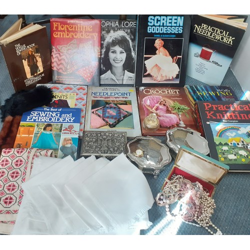 141 - A mixed lot to include books on sewing and actresses, a white cotton tablecloth and napkins, a cross... 