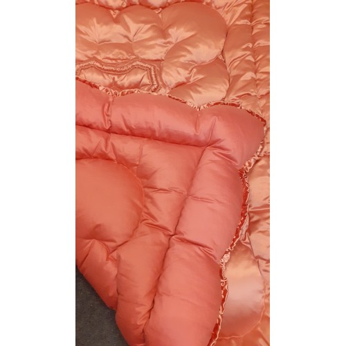 146 - A 1930's-1950's dusty pink padded and embroidered satin eiderdown having a ruffled trim, suitable fo... 