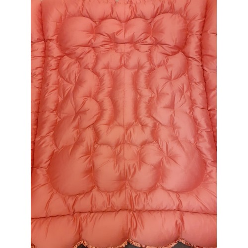 146 - A 1930's-1950's dusty pink padded and embroidered satin eiderdown having a ruffled trim, suitable fo... 