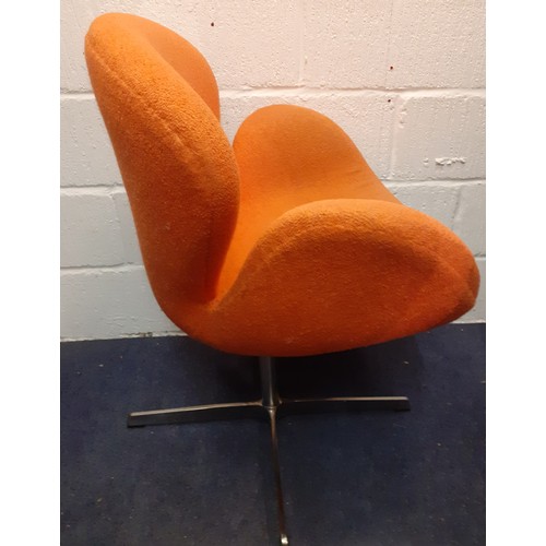 198 - A 20th Century Arne Jacobsen style Swan chair having original orange upholstery on a chrome swivel b... 