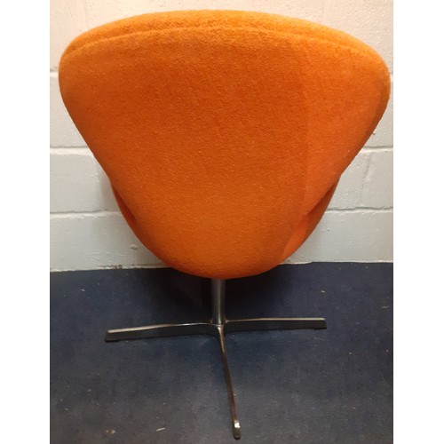 198 - A 20th Century Arne Jacobsen style Swan chair having original orange upholstery on a chrome swivel b... 