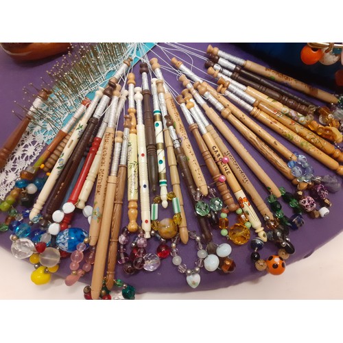 164 - A quantity of lace bobbins on 2 lace-making cushions to include wooden, bone and plastic bobbins, so... 