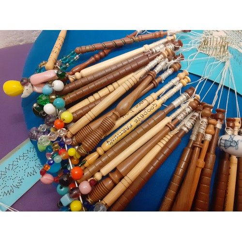 164 - A quantity of lace bobbins on 2 lace-making cushions to include wooden, bone and plastic bobbins, so... 