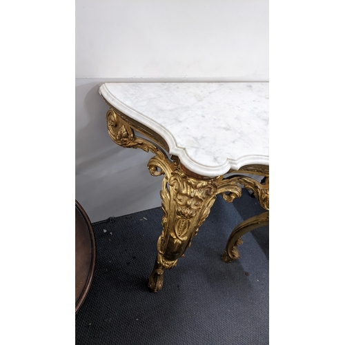 209 - A 19th century Louis XV style gilt console table having a marble top on ornate cabriole legs, 91cm h... 