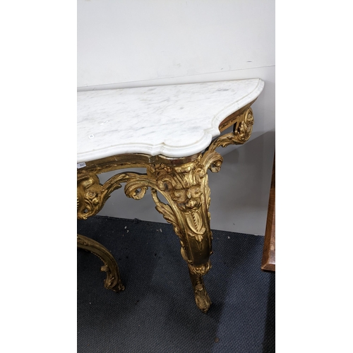 209 - A 19th century Louis XV style gilt console table having a marble top on ornate cabriole legs, 91cm h... 