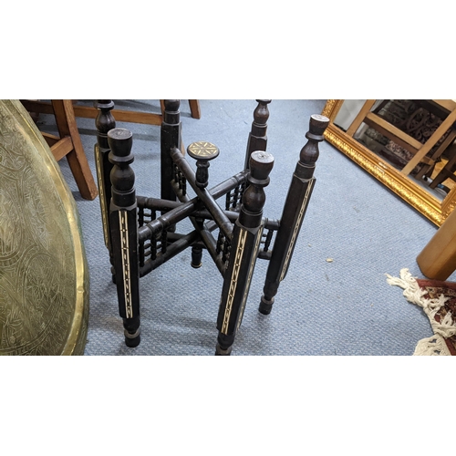 211 - An early 20th century Middle Eastern brass tray topped folding table, 45.5cm h x 60cm w
Location: BW... 