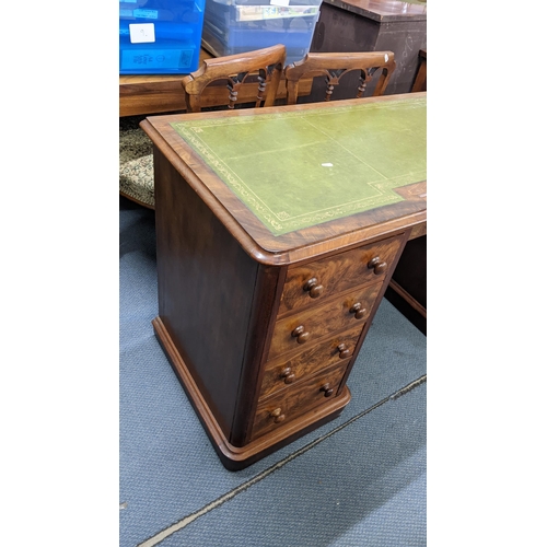 212 - A Victorian mahogany twin pedestal desk having a green leather topped scriber and nine drawers, 75.5... 