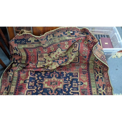 217 - A Turkish hand woven red ground runner having five central motifs and repeating pattern, 322cm x 140... 