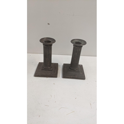 262 - A pair of silver reeded column dwarf candlesticks on square weighted bases
Location:6.1
If there is ... 