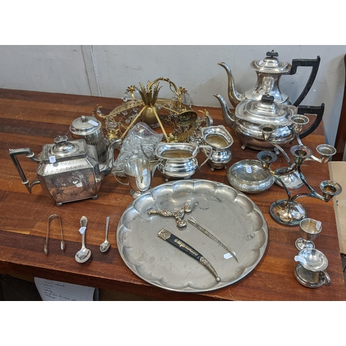 232 - A group of silver plated items to include a brass chandelier, teapots, candlesticks, sugar bowls, a ... 