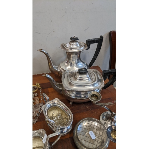 232 - A group of silver plated items to include a brass chandelier, teapots, candlesticks, sugar bowls, a ... 