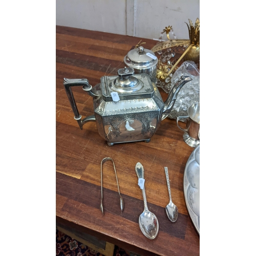 232 - A group of silver plated items to include a brass chandelier, teapots, candlesticks, sugar bowls, a ... 