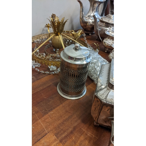 232 - A group of silver plated items to include a brass chandelier, teapots, candlesticks, sugar bowls, a ... 