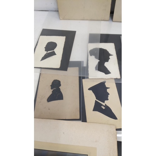 242 - A collection of photographs and silhouettes to include two portrait black and white photography sign... 