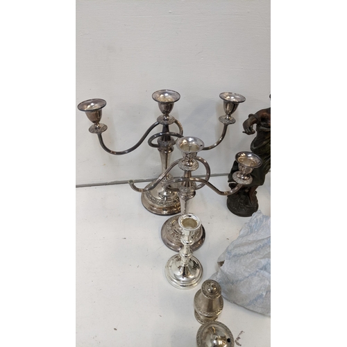 249 - A mixed lot of metalware to include a candelabra (one A/F) two Victorian Spelter figures, flatware a... 