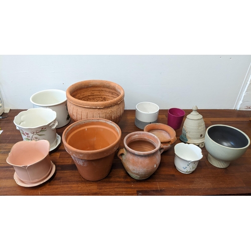 256 - A collection of pots to include four terracotta garden plants ranging in size, four ceramic indoor p... 