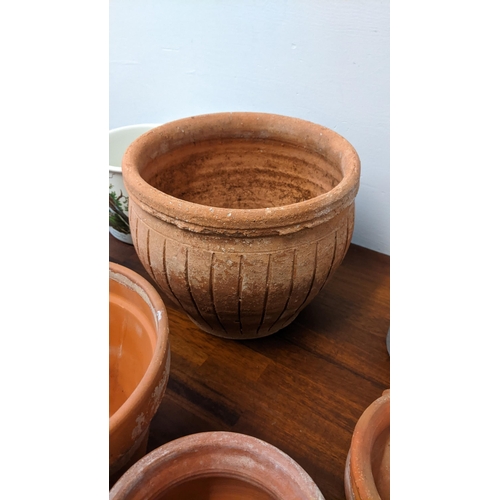 256 - A collection of pots to include four terracotta garden plants ranging in size, four ceramic indoor p... 