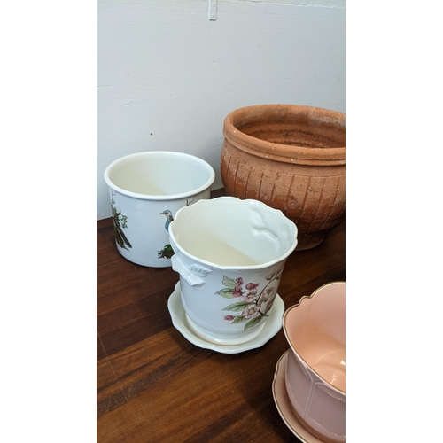 256 - A collection of pots to include four terracotta garden plants ranging in size, four ceramic indoor p... 