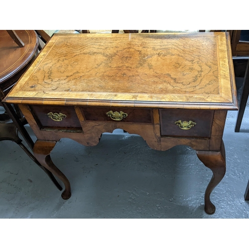 294 - An early 20th century Queen Anne revival walnut lowboy together with a can back armchair
Location:G
... 