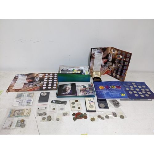 303 - A selection of mainly foreign and commemorative coinage and banknotes to include a 2006 Elizabeth II... 