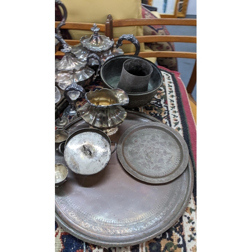 397 - Mixed metalware to include a silver plated tea service, pewter tankards, brass candlesticks and othe... 