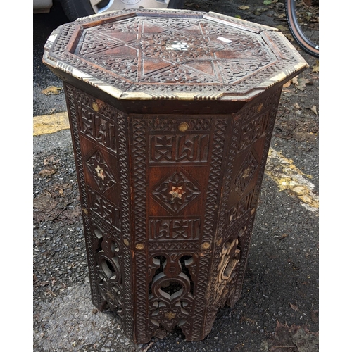 411 - A late 19th/early 20th century Middle Eastern octagonal formed table, inlaid with bone and carved re... 