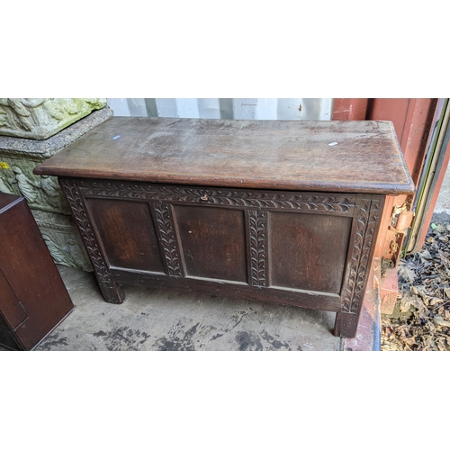 418 - An early 20th century oak coffer, having a hinged top and carved with acanthus leaves, 51.5cm h x 91... 