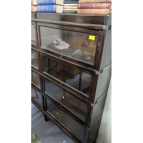 308 - Early 20th Globe Wernicke -style bookcase with eight glazed up and over doors on squared tapered 136... 