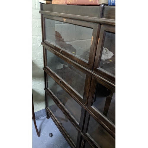 308 - Early 20th Globe Wernicke -style bookcase with eight glazed up and over doors on squared tapered 136... 