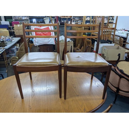 330 - A G plan teak oval draw leaf dining table and a set of six G plan dining chairs (table 206cm extende... 